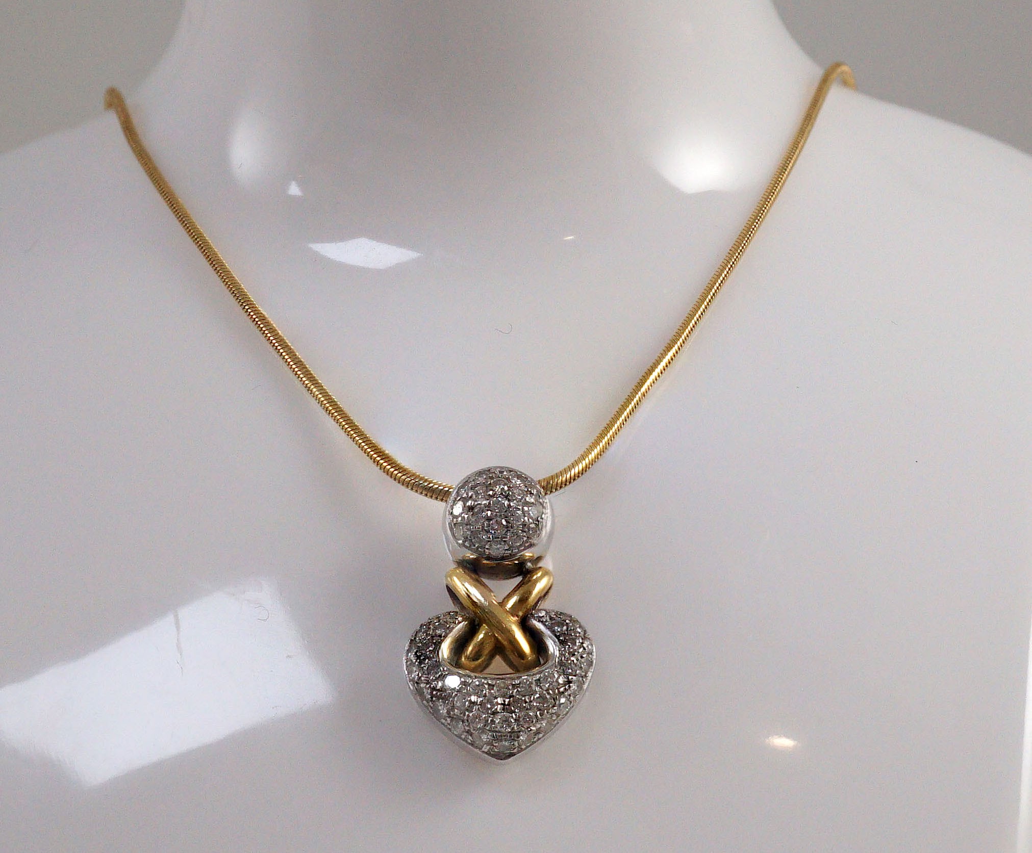 A cased modern Italian 18ct two colour gold and pave set diamond heart shaped pendant by Chimento, on an 18ct gold snake link chain